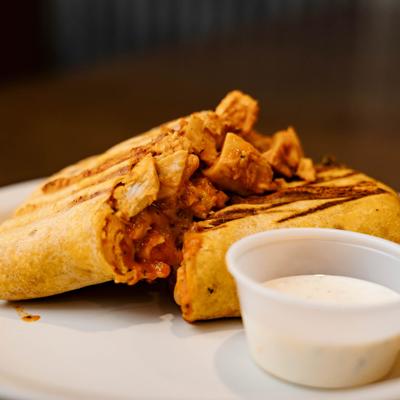 Buffalo Chicken Wrap paired with a dipping sauce.