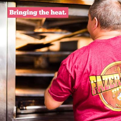 A staff member operating the oven.