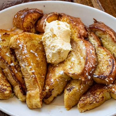 Classic French Toast served with fresh whipped butter and maple syrup.