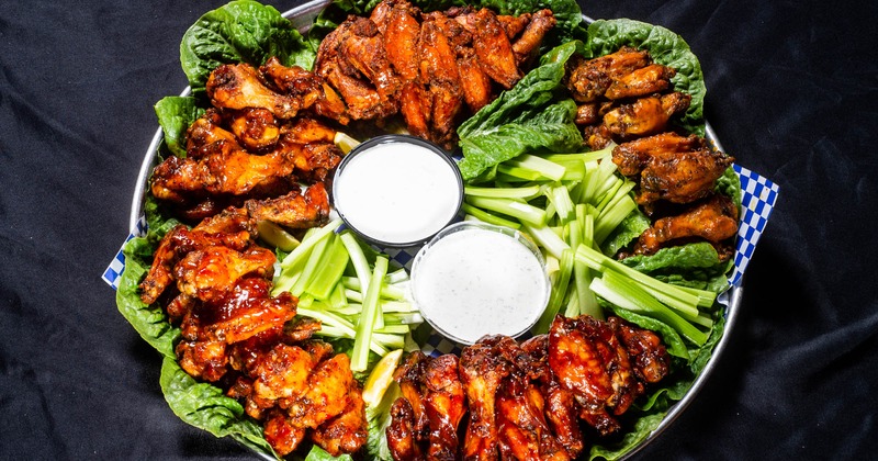 BBQ wings with sauce dips and celery