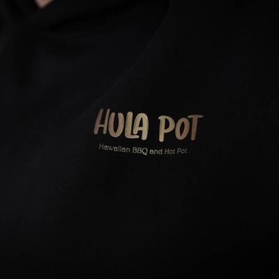 Hula Pot logo on the black hoodie, zoomed in.