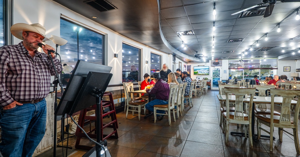 Interior, dining space with a country singer sining