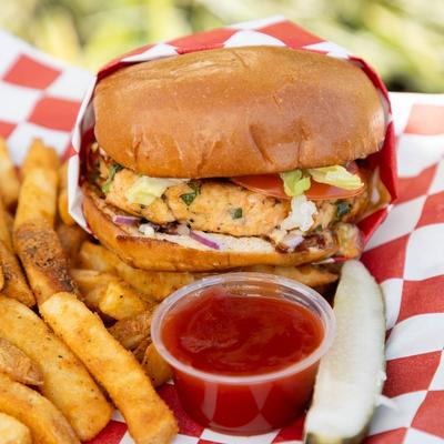 Salmon Burger with fries and dipping sauce.