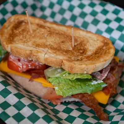 Club sandwich with cheese, turkey, ham, bacon, lettuce and tomato.