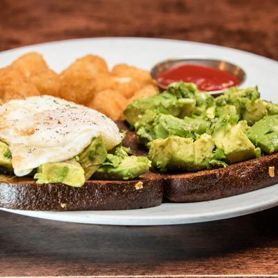 Avocado Toast, with a fried egg, and tater tots.