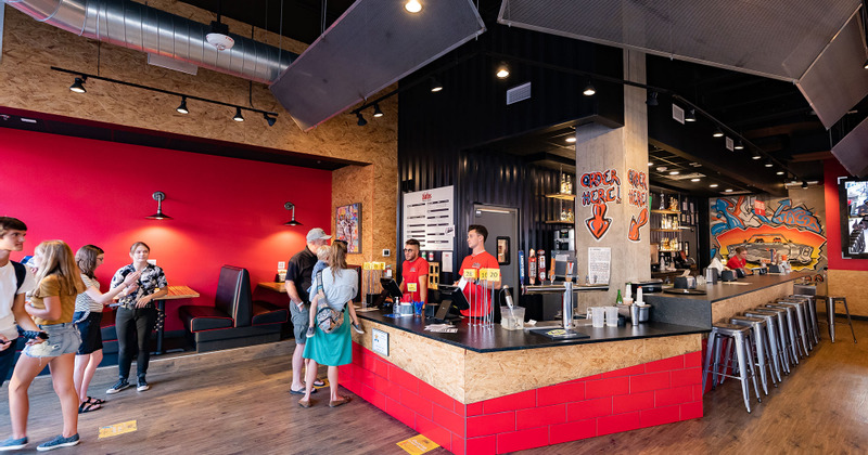 Interior, staff conversing with customers at a counter