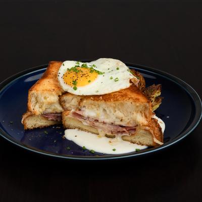 Croque Madame, griddled brioche, ham, gruyere, bechamel, sunny egg, brunch potatoes.