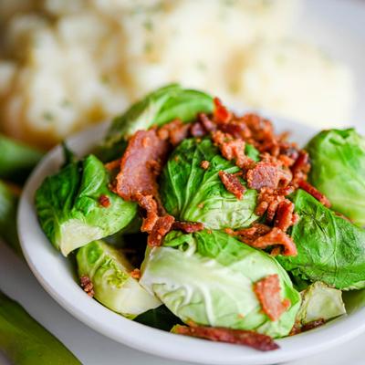 Broiled Salmon plate, a close up of side Brussels sprout salad with bacon.