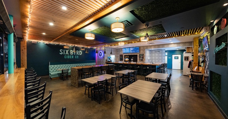Interior,  tables in seating area with bar behind