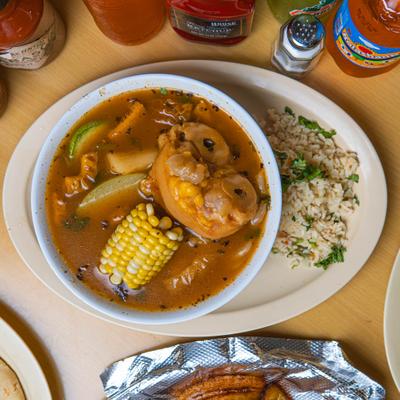 Chicken stew with corn served with rice.