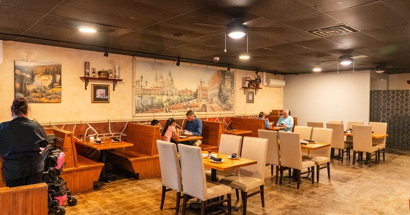Cozy interior dining area with dining tables set for guests