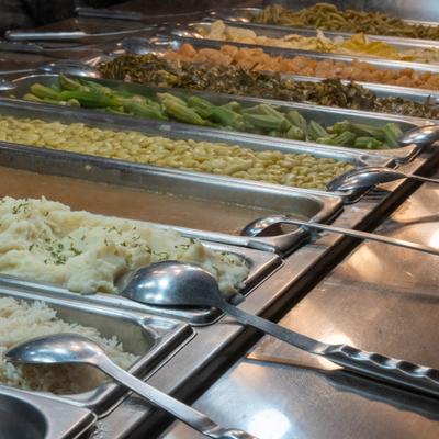 Buffet serving station with food trays.