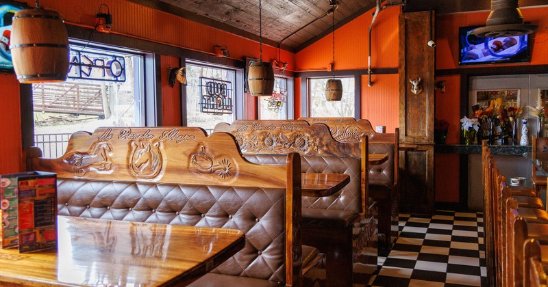 Cozy restaurant interior with wooden booths, rustic decor