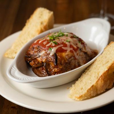 Eggplant Parmesan served with bread.