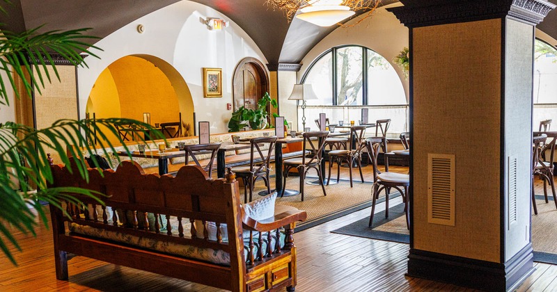 Inviting restaurant interior with warm lighting, wooden tables, and chairs