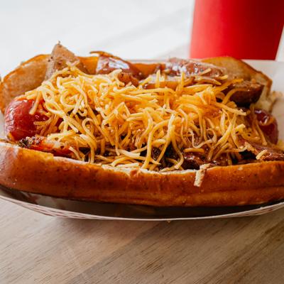 Breakfast dawg with bacon and grated cheese.