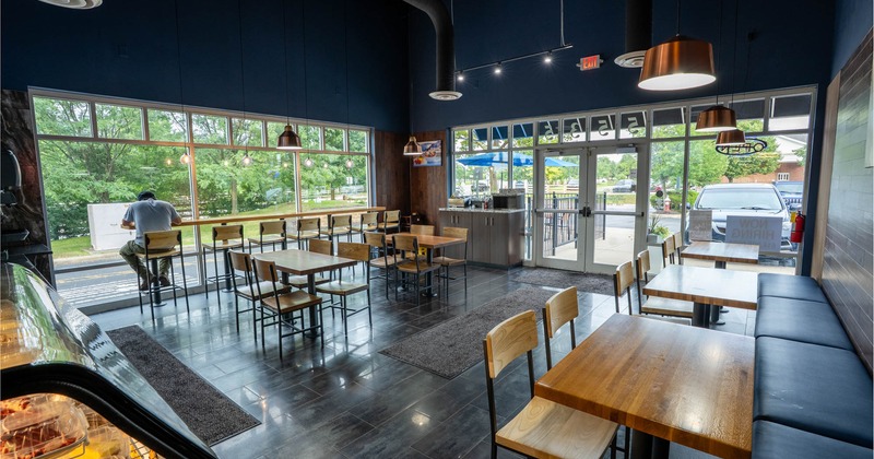 Interior, dining area, restaurant entrance, tables for four, banquette bench with tables