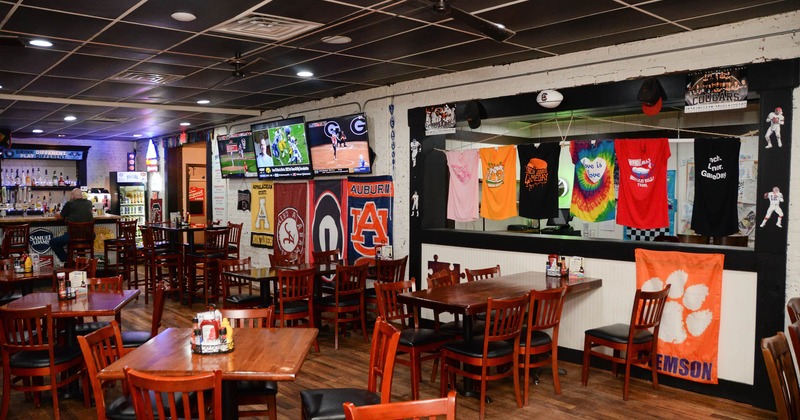 Interior, wide view, dining area, tv screens and flags on the wall