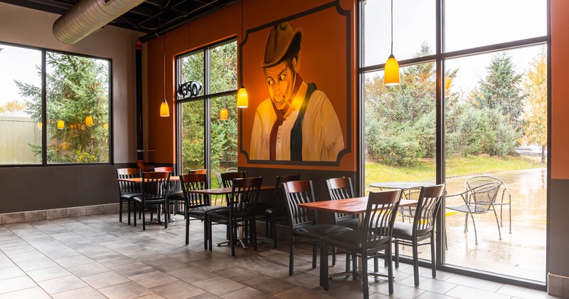 Interior, tables, chairs, large windows, view outside, wall mural