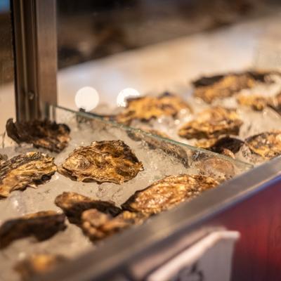 Oysters on ice in a cool seafood display case