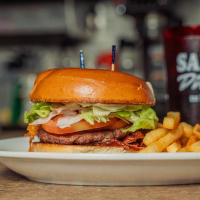 Baja burger with bacon and French fries.