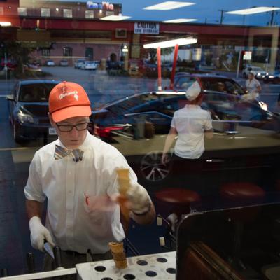 night scene cone baking cars on the curb.