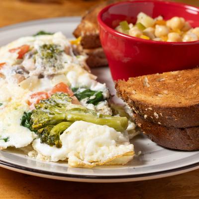 Egg white omelet with veggies and ricotta served with toast and chickpea salad.