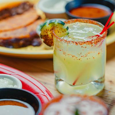 Margarita with chili rim and cucumber garnish.