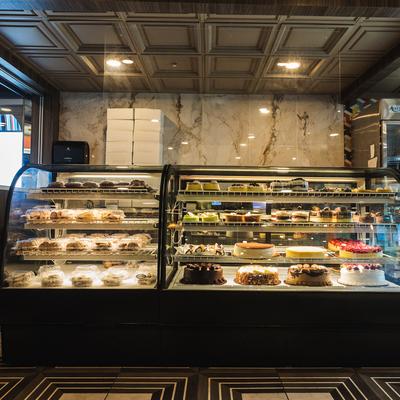 Refrigerated display cabinet with various cakes and sweets