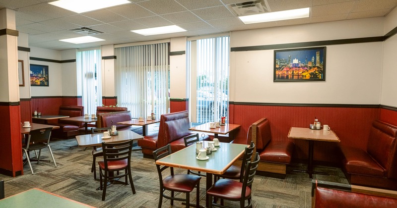 Interior of a diner with red leather booth seating and wooden tables