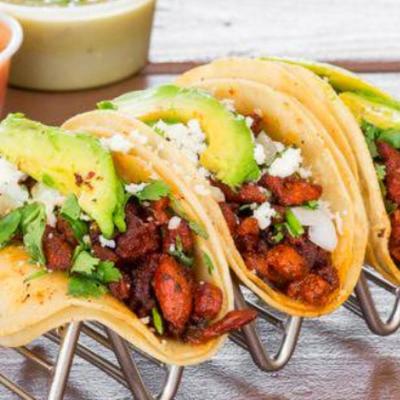 Portion of tacos, with two dips in the background.