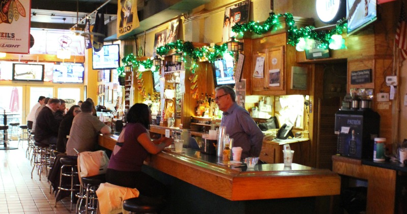 Restaurant interior, guests sitting at the bar