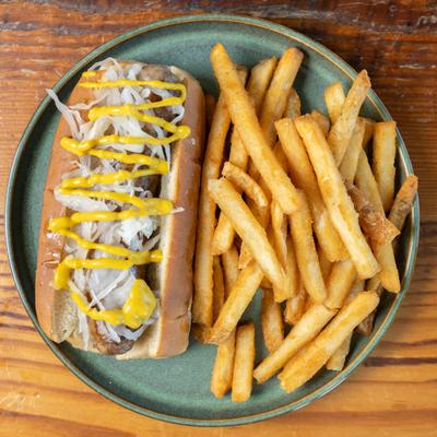 Bratwurst hot dog with fries.