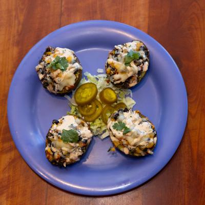 Southwest Stuffed Avocados topped with white sauce and fresh cilantro.