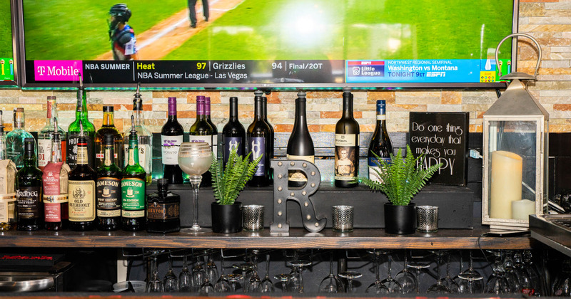 Bar Area - flat screen TV attached to the wall, bottles of wine and alcoholic drinks