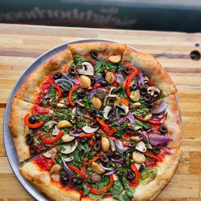 Vegan Pie with spinach, mushrooms, red onions, roasted garlic and black olives.