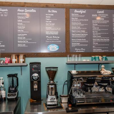 Coffee makers and menus behind the bar.