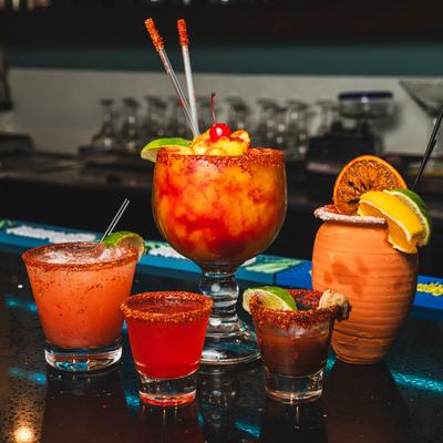 Assorted cocktails, group shot on a bar counter.