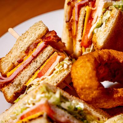 Club sandwiches with onion rings.