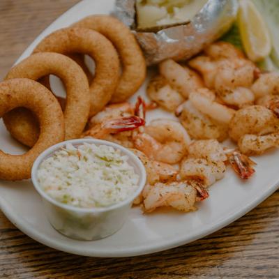 Broiled Jumbo Shrimp served with onion rings, baked potato and coleslaw.