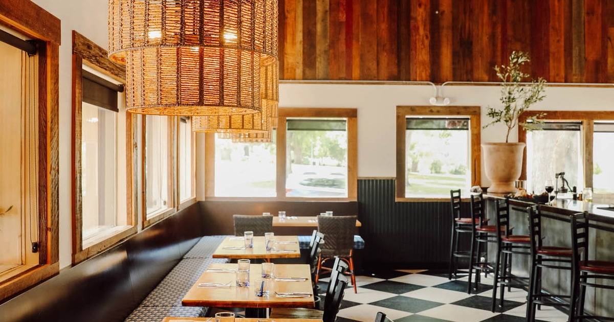 Dining area with woven pendant lights, set tables, and checkered floors