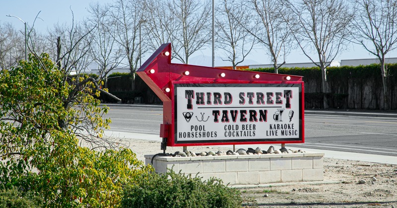 A billboard lights up, a big directional sign in front the restaurant