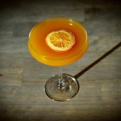 Porn Star Martini cocktail with an orange wheel.