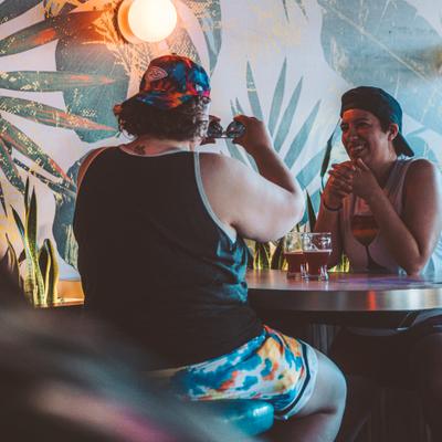 Interior, two seated guests enjoying drinks