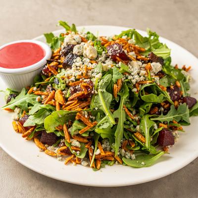 Arugula salad with poached pears, Cajun almonds, gorgonzola, and raspberry vinaigrette.