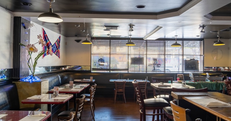 Interior, dining area, banquette seating, high seating tables with stools, windows with blinds