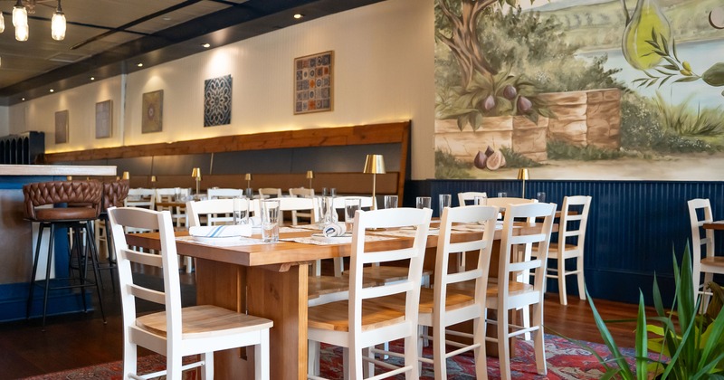Warm and cozy interior dining area, large table set for eight guests