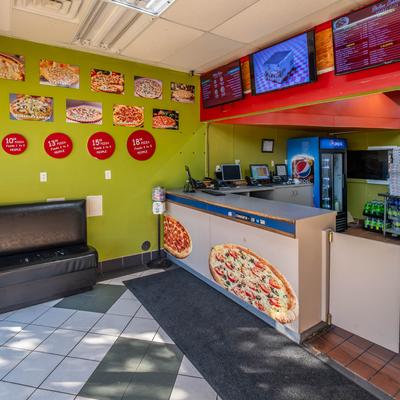 Interior with a service counter and digital menu boards.