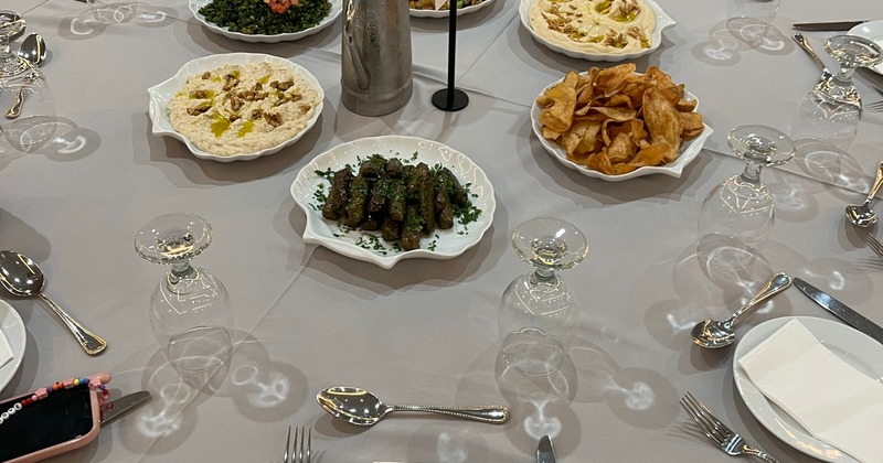 A plate with plates of food, tableware, silverware, and glassware