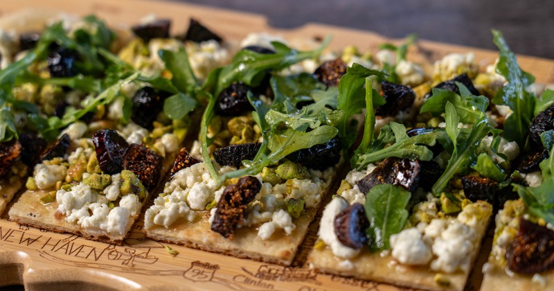 Fig Flatbread served on a wooden board